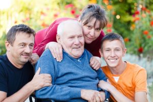 loving family visiting grandfather at the nursing home.